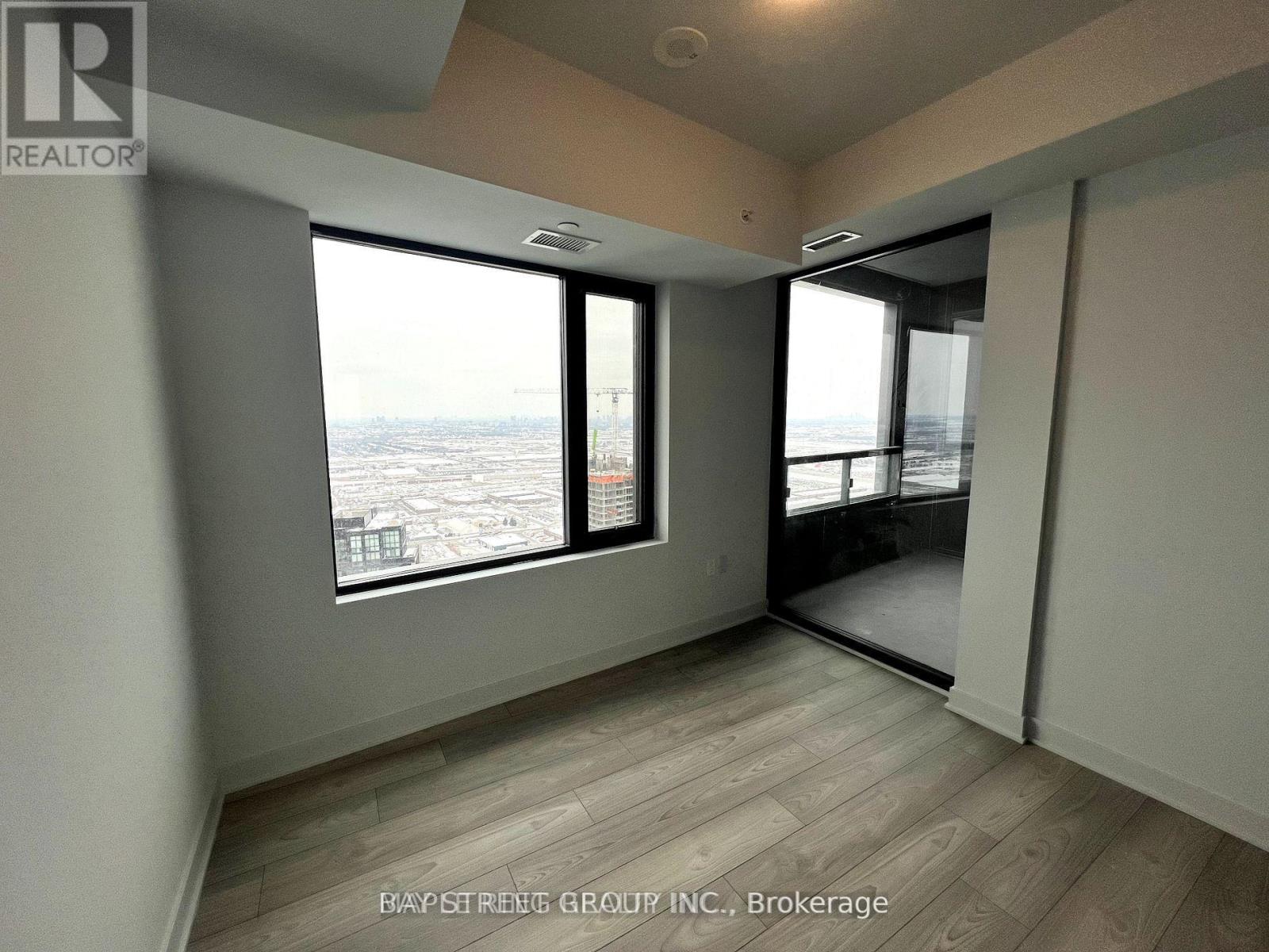 A room with a view of the city from a large window.