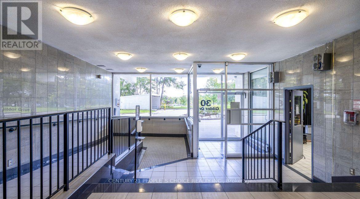 A hallway with a bench and a glass door leading to a balcony.