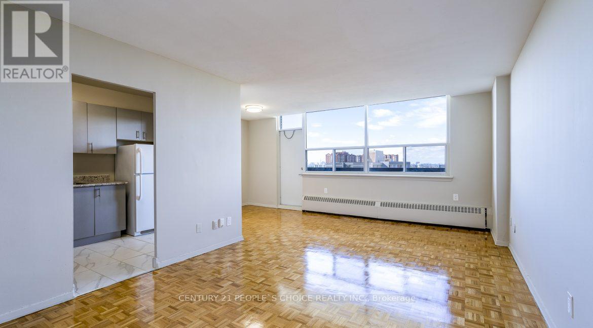 A spacious living room with a view of the city through the windows.