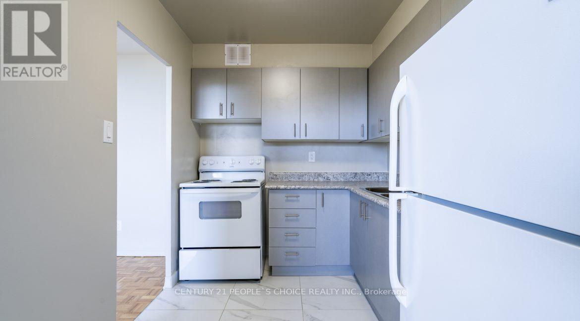 A kitchen with white appliances and cabinets is shown.