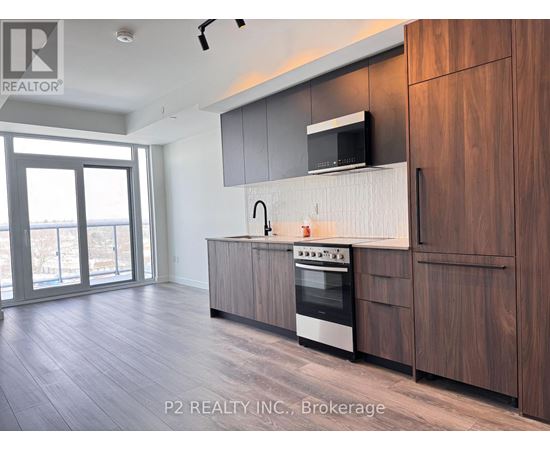 A modern kitchen with wooden cabinets and a stainless steel oven.