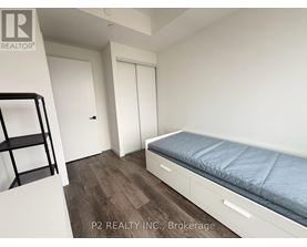 A bedroom with a bed, a chair, and a desk.