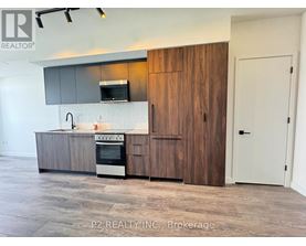 A modern kitchen with a wooden cabinet and a stove top oven.
