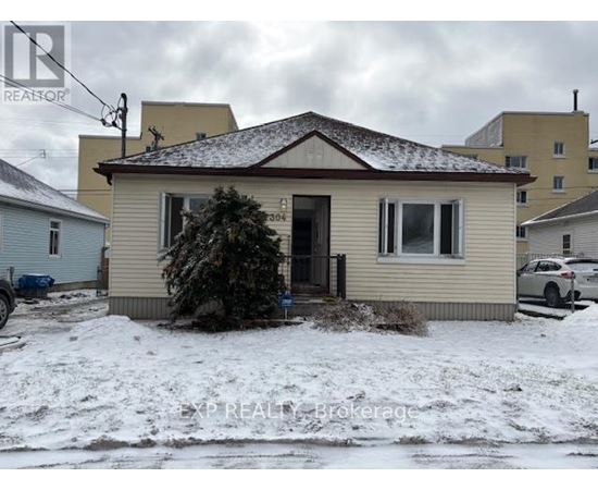 A house with a brown roof and a small front yard.