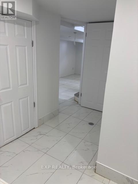 A white door is on the left and a white wall is on the right.