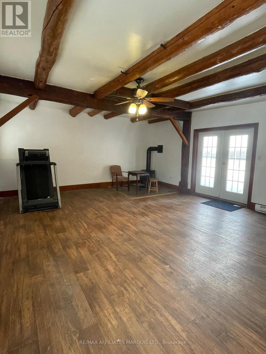 A room with wooden floors and a ceiling fan.