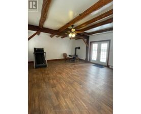 A room with wooden floors and a ceiling fan.