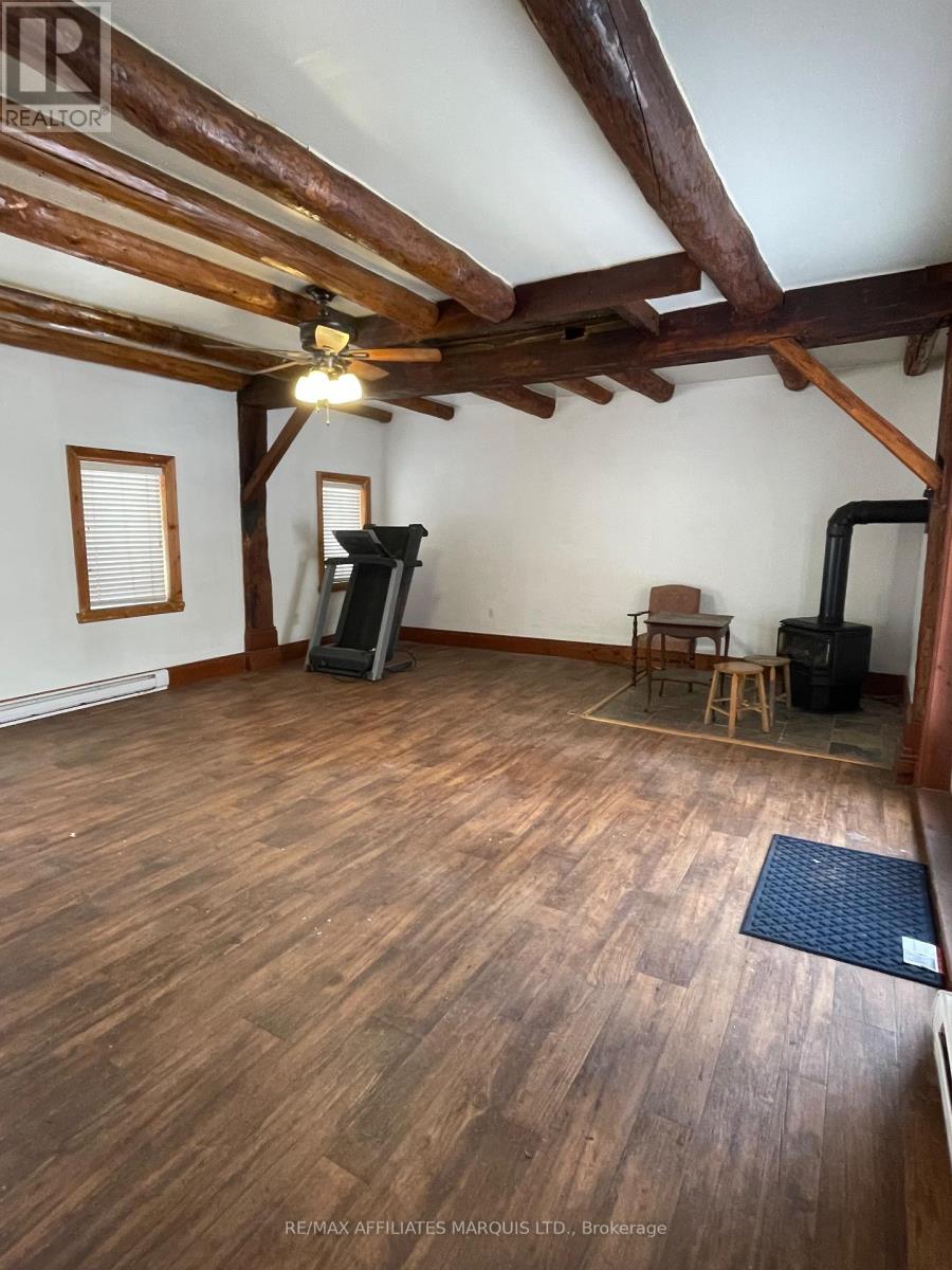 A room with wooden floors and a ceiling fan.