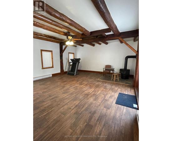 A room with wooden floors and a ceiling fan.