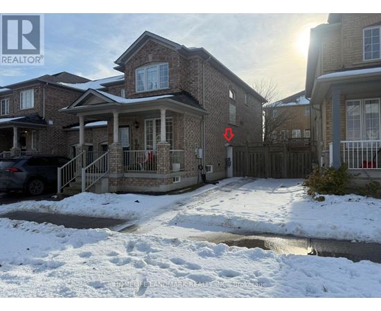 A house with a snow-covered ground in front of it.