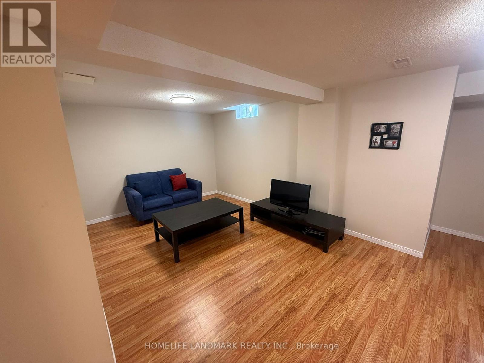 A living room with a blue couch and a black coffee table.