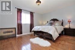 A bedroom with a large bed and a wooden floor.