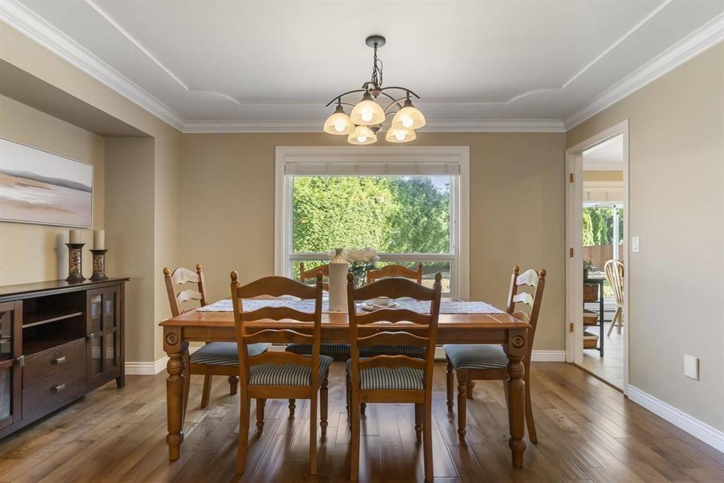 A dining room with a table set for six.
