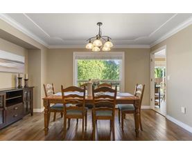 A dining room with a table set for six.