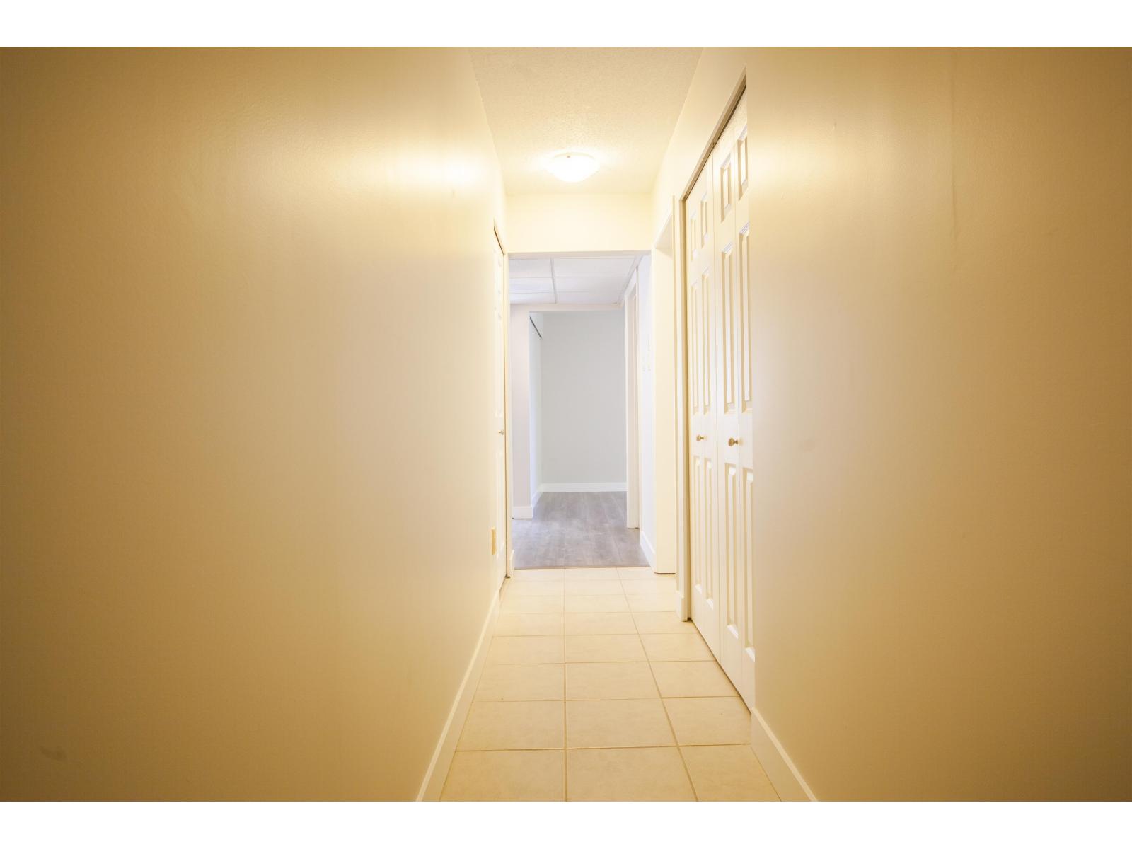 A hallway with a light at the end.