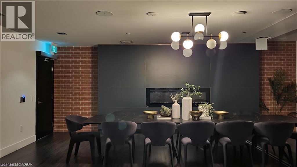 A modern dining room with a dark table and chairs.
