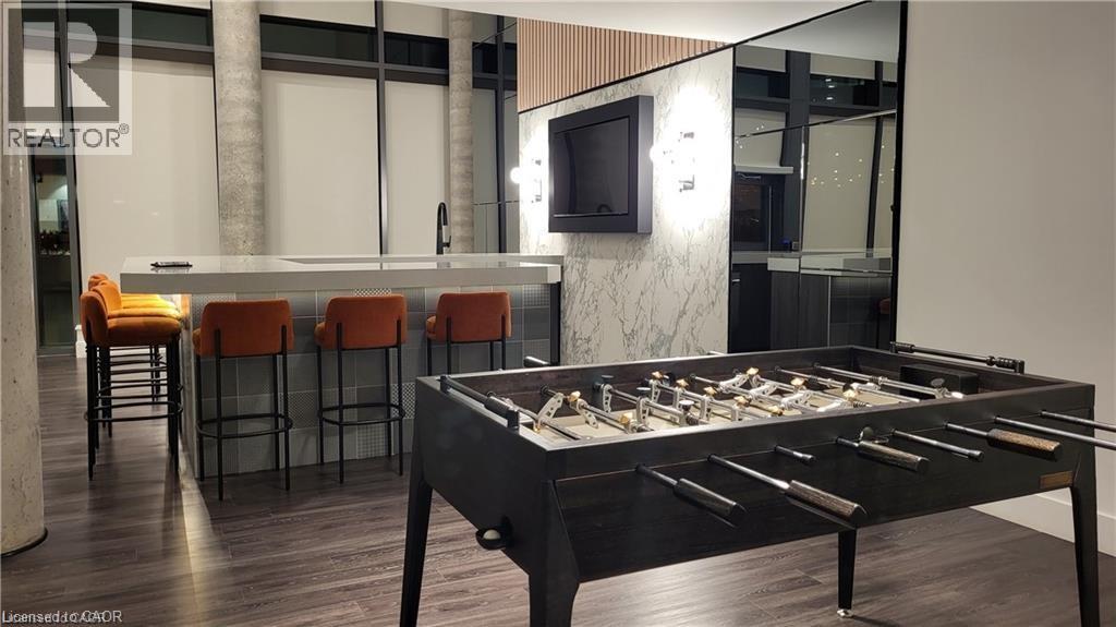 A pool table in a room with a bar area.