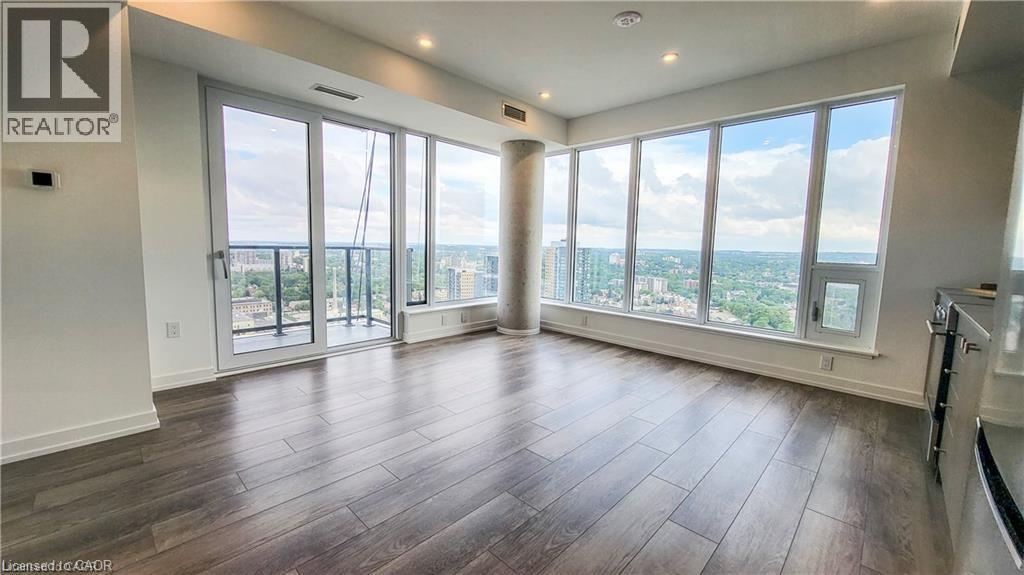A spacious room with a large window overlooking the city.
