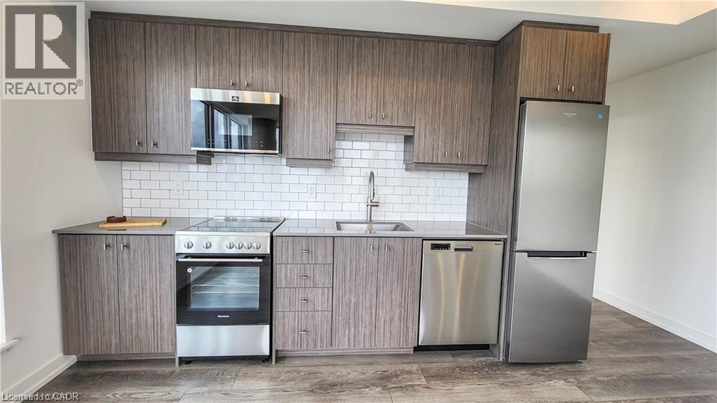 A modern kitchen with wooden cabinets and stainless steel appliances.