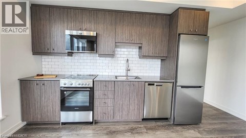 A modern kitchen with wooden cabinets and stainless steel appliances.