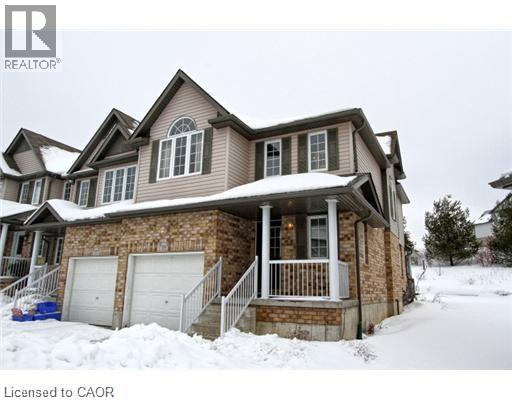 A house with a brown roof and a white garage door.