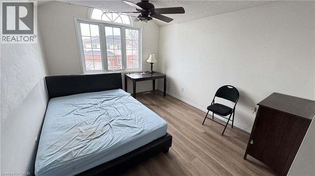 A bedroom with a bed, chair, and a small table.
