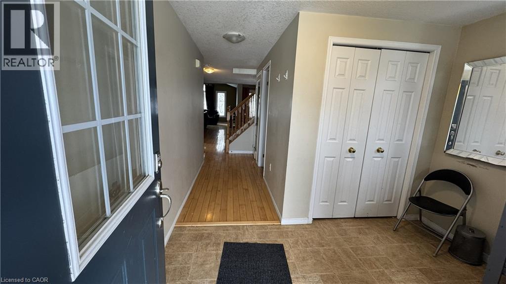 A hallway with a blue carpet and a white door.