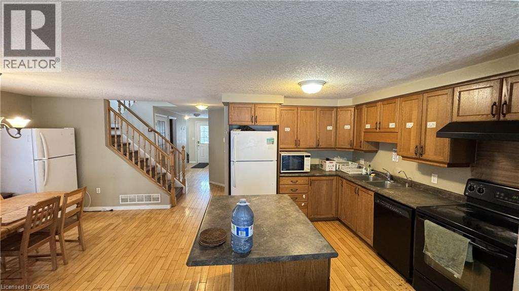 A kitchen with wooden cabinets and a black countertop.