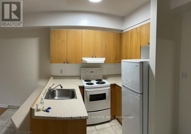 A kitchen with wooden cabinets and white appliances.