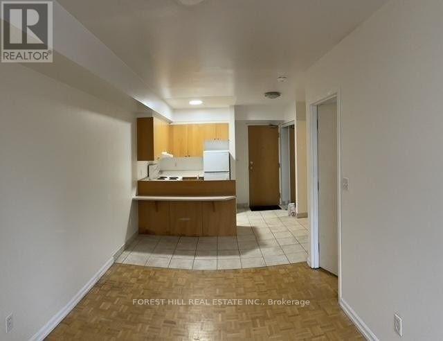 A real estate listing image of a kitchen area with a countertop and cabinets.
