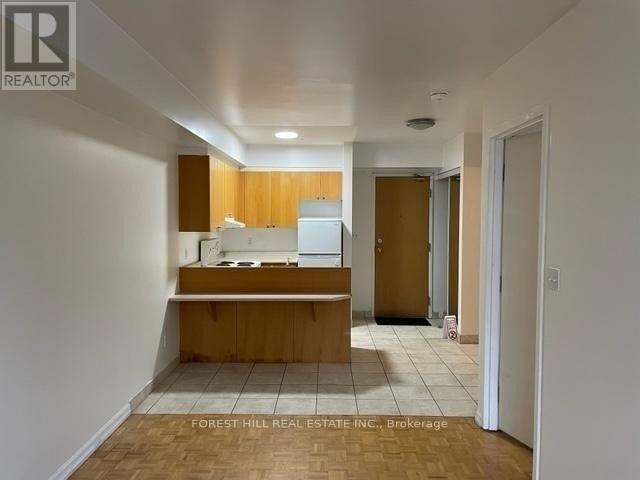 A kitchen area with a counter and cabinets.