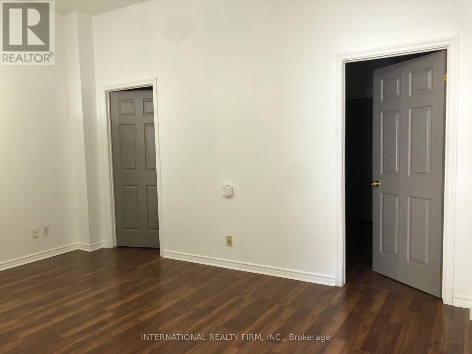 A room with two doors, one of which is open.
