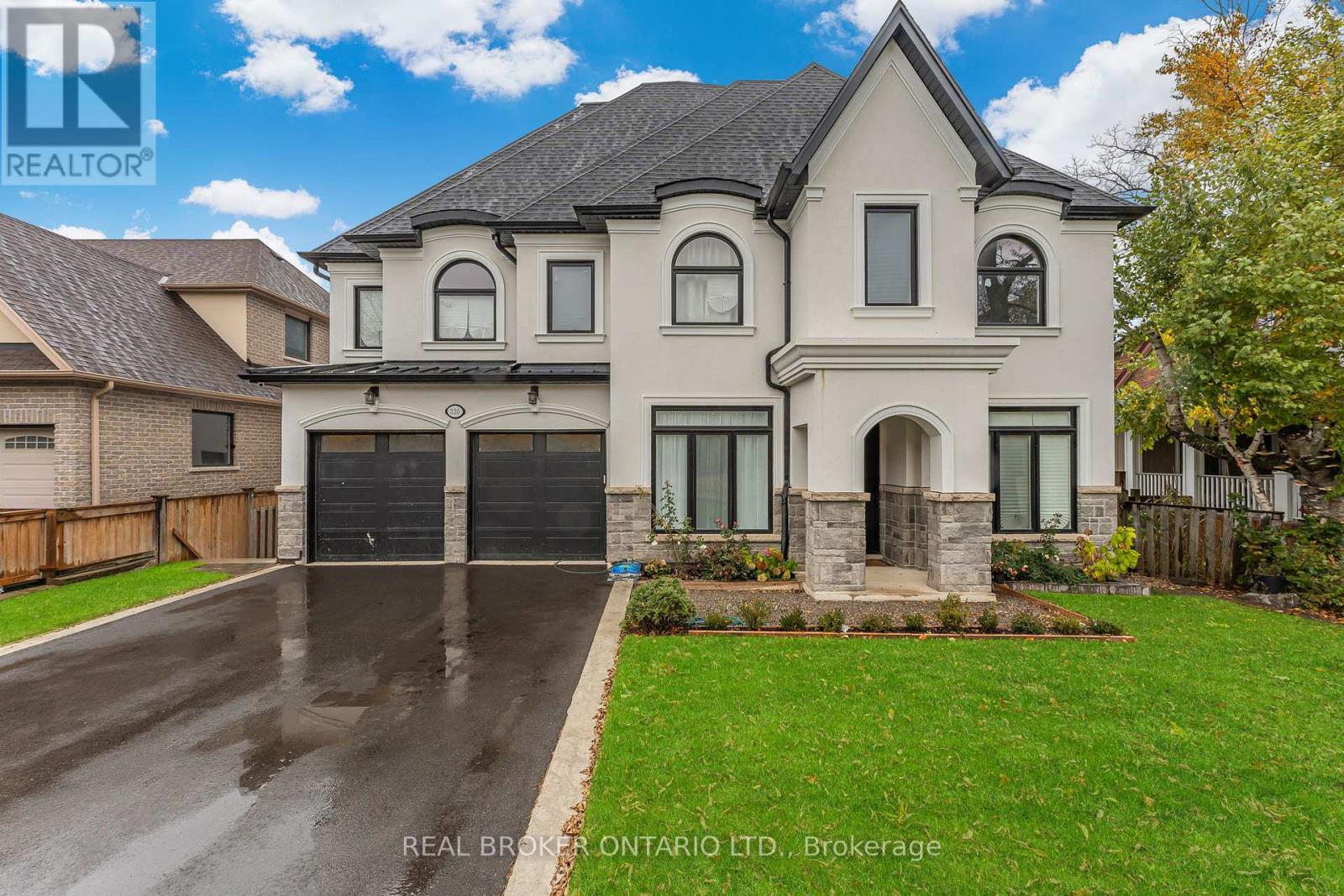 A large, two-story house with a garage is for sale.