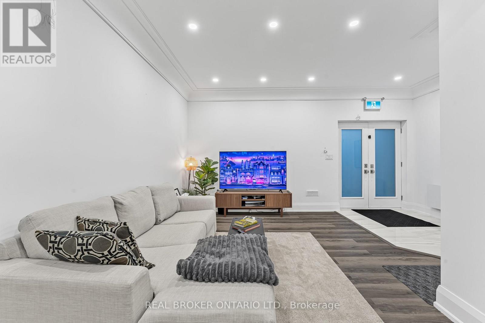 A living room with a grey couch and a flat screen TV.