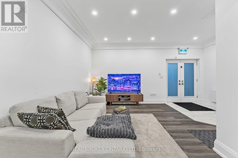 A living room with a grey couch and a flat screen TV.