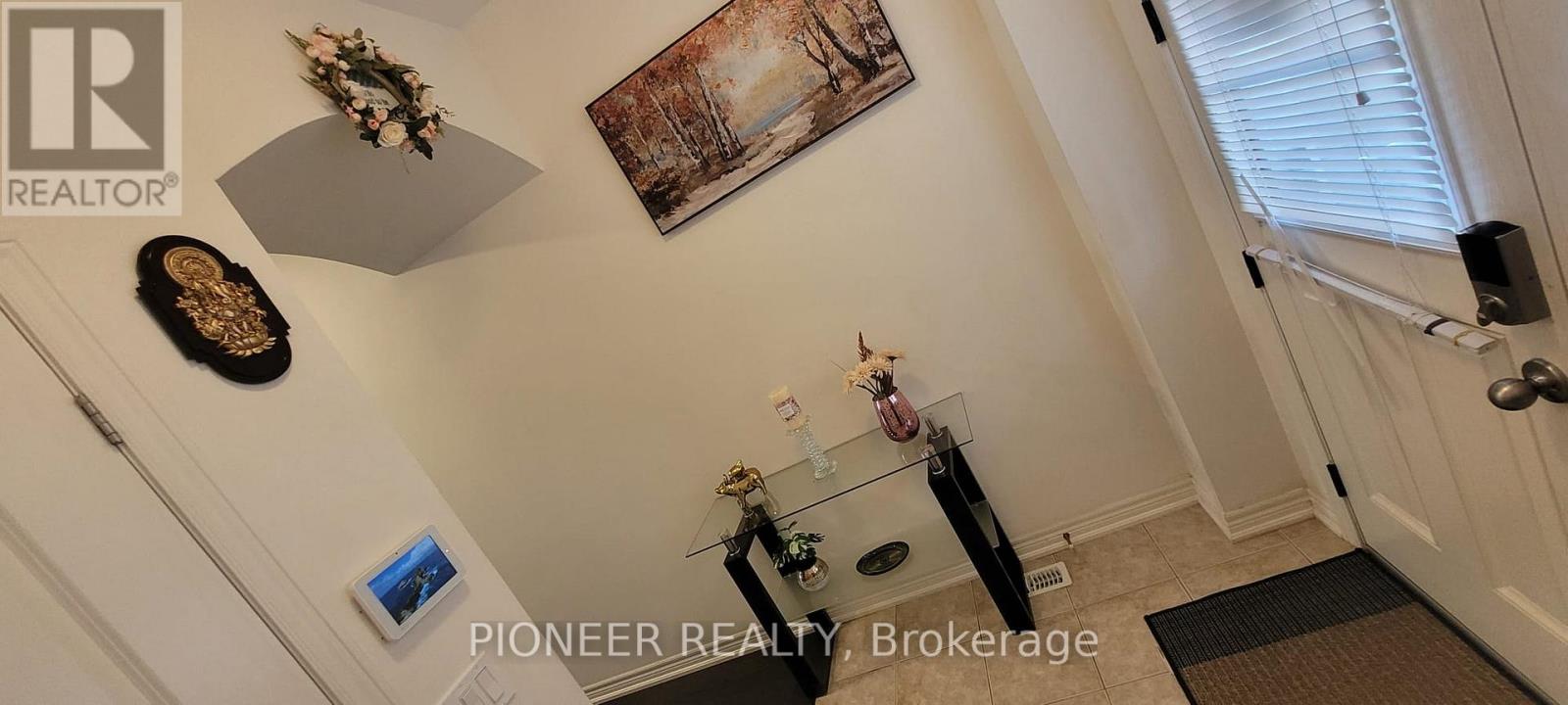 A hallway with a brokerage sign on the wall.