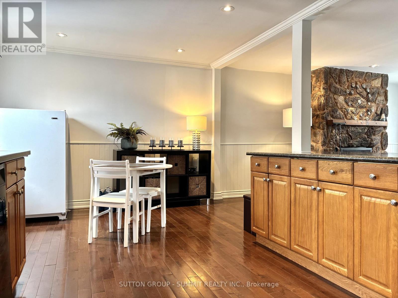 A kitchen with wooden cabinets and a white fridge.