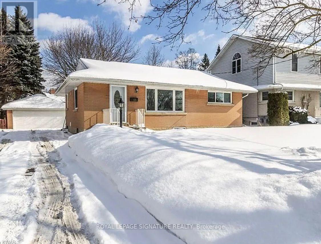 A house with a snow-covered ground and a clear sky.