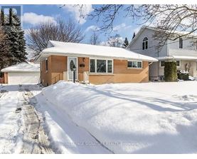A house with a snow-covered ground and a clear sky.