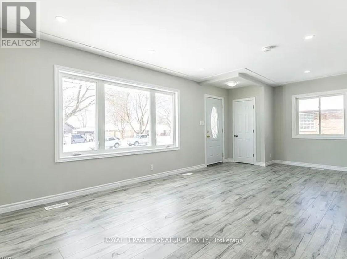 A spacious room with grey flooring and white walls.