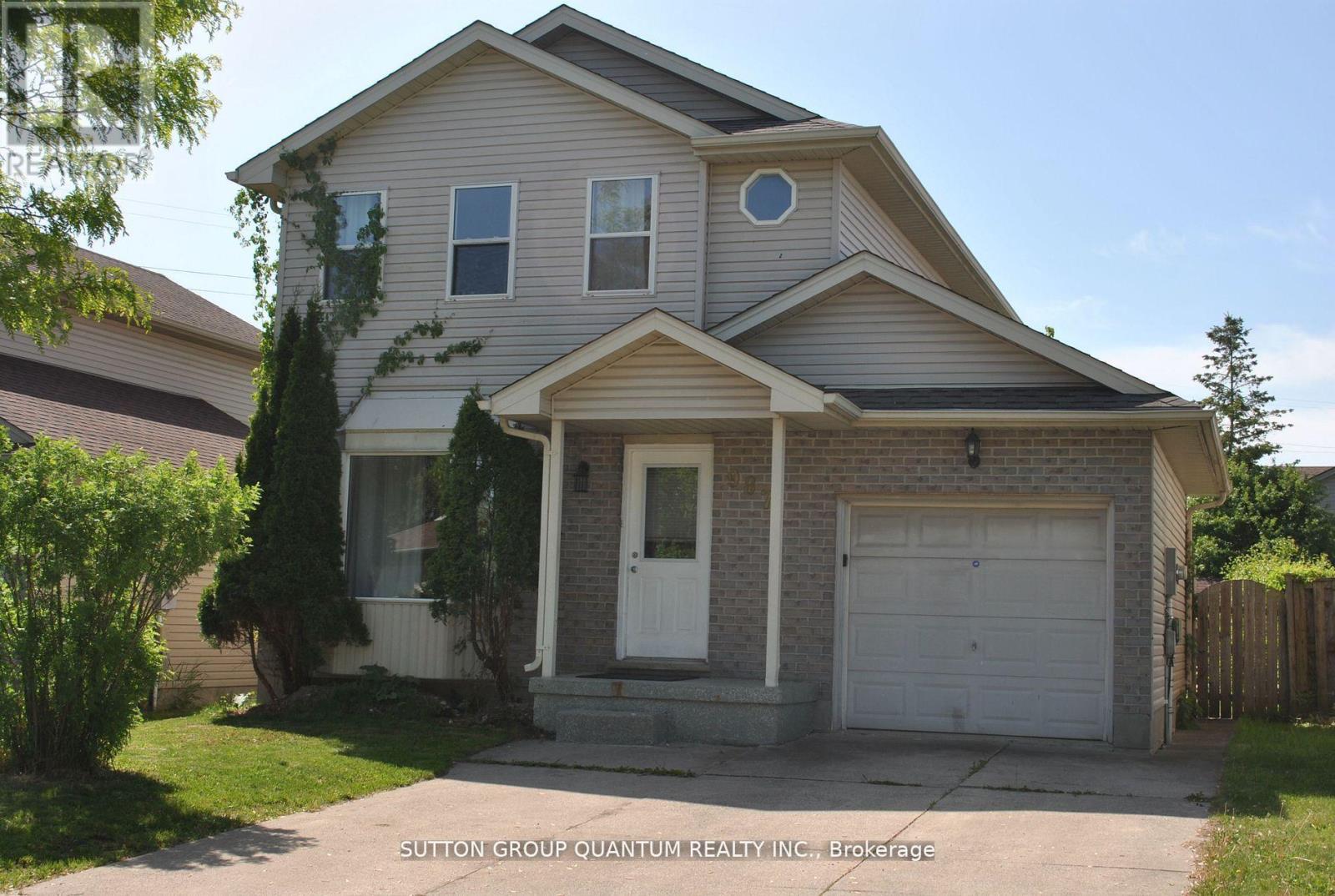 A house with a white garage door and a small window above it.