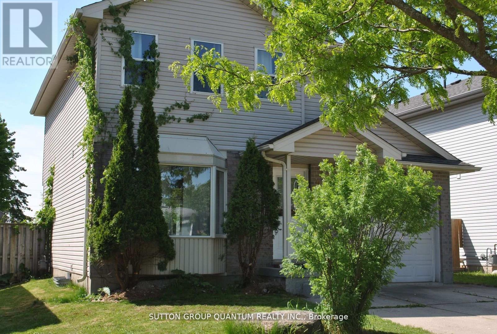 A house with a tree in front of it.