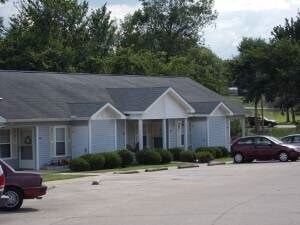 A house with a car parked in front of it.