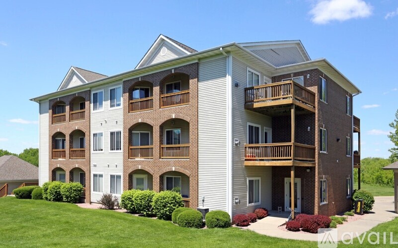 A large apartment building with a balcony on the second floor.