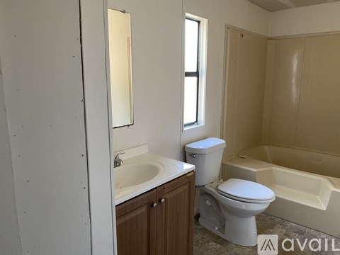 A bathroom with a toilet, sink, and bathtub.