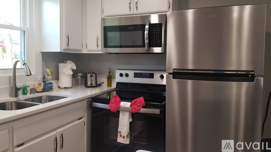 A modern kitchen with a stainless steel refrigerator and a black oven.