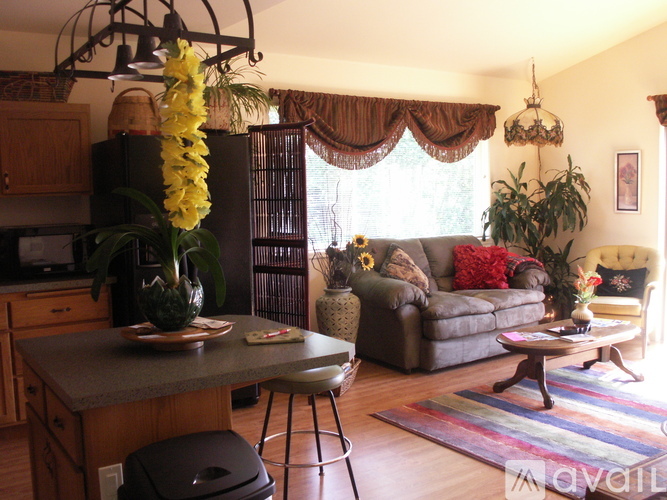 A kitchen with a table and chairs and a couch.