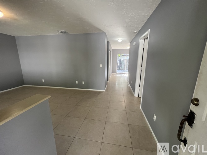 A room with grey walls and a tiled floor.