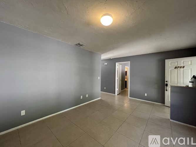 A room with grey walls and a tiled floor.