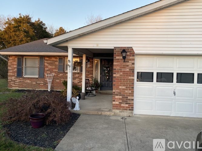 A house with a white garage door and a brick exterior.